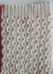 A close up shot of the rippling lacy pattern of the sock 