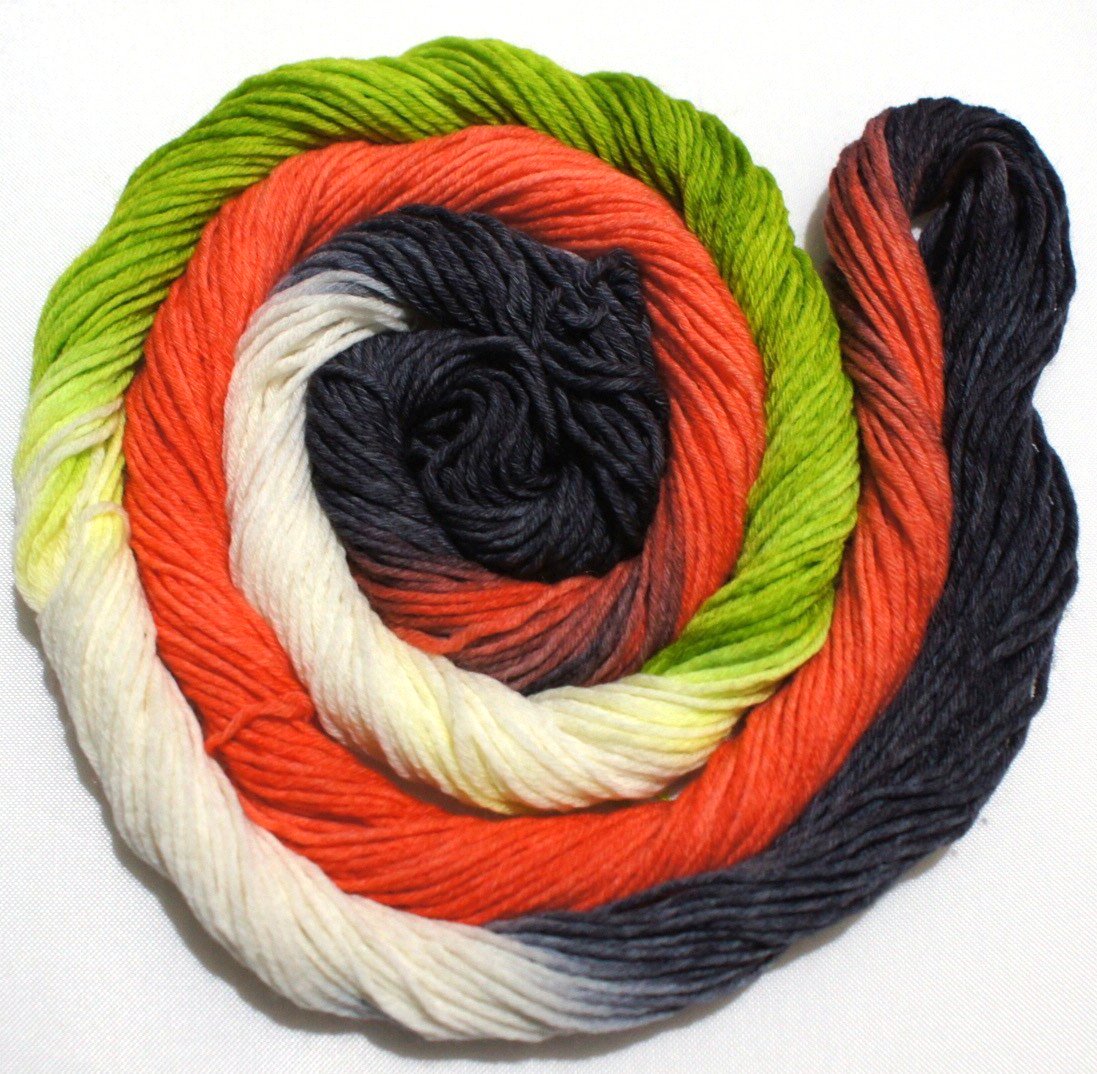 A bright swirl of yarn curls around itself like a labyrinth against a white background.