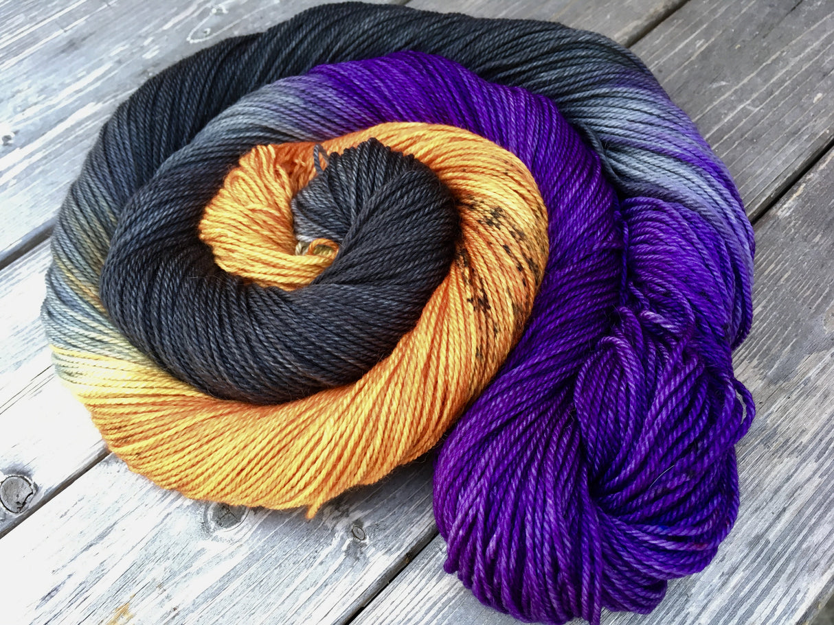 A bright swirl of yarn curls around itself like a labyrinth against a white background.