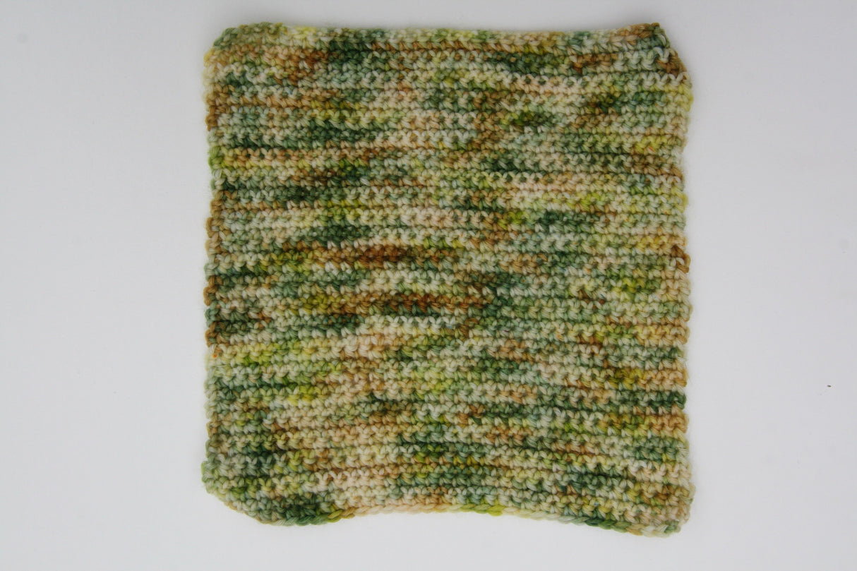A crocheted swatch of Gecko Meadow rests on a clean white background.