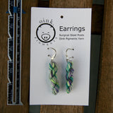 miniature skein earrings rest on a white card with the Oink Pigments logo and text at the top of the card.  a small ruler rests on the left.