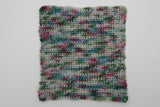 a crocheted swatch of blackberry brambles showcases the variety of color in this yarn. 