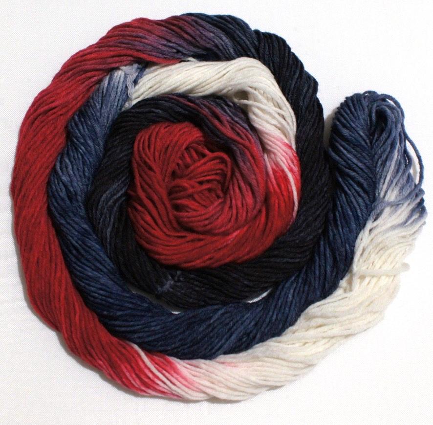 A bright swirl of yarn curls around itself like a labyrinth against a white background. 