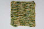 A crocheted swatch of Gecko Meadow rests on a clean white background. 