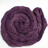 A skein of yarn swirls around itself like a labyrinth against a clean white background.