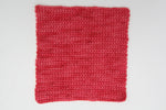 A crocheted swatch demonstrates the depth of color in this colorway.