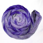 A rich swirl of yarn rests on a crisp white background.