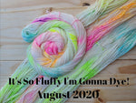 yarn laid out with another skein twisted into a spiral, all skeins are colored a neon rainbow speckle, black text reads "it's so fluffy I'm gonna dye! August 2020"